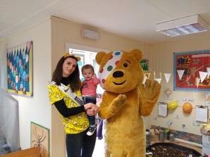 Katie Kitson, Beacon Wealth Group marketing manager, and 1-year-old Eddie Kitson with Pudsey Bear