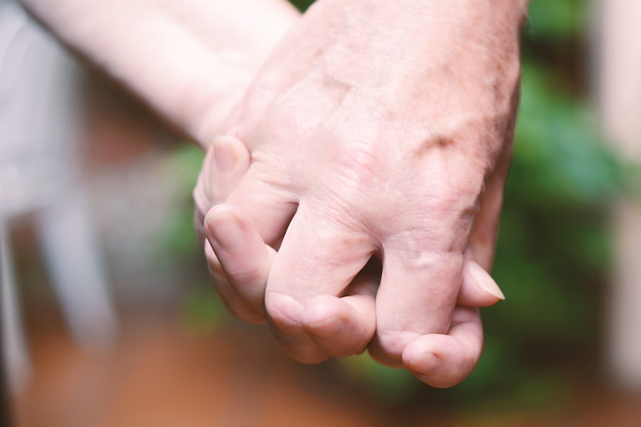 Elderly care - couple holding hands